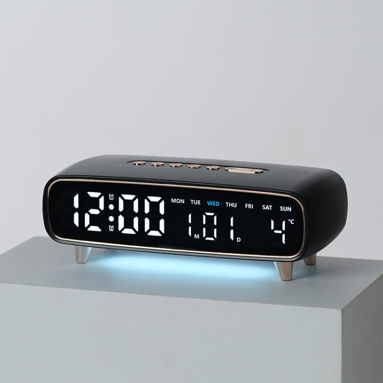 Black digital alarm clock with date, weekday, temperature, and time display on front
