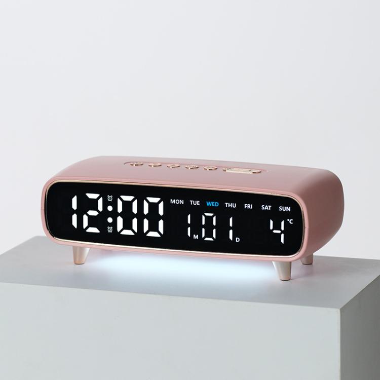 Pink digital alarm clock with date, weekday, temperature, and time display on front