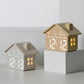 House-shaped digital alarm clocks in yellow and gray, each with illuminated time display