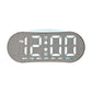 Digital alarm clock with gray fabric shell and white LED time display