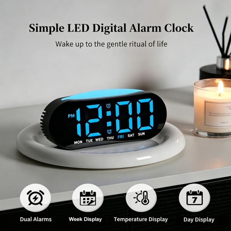 Digital alarm clock with blue LED glow on bedside charging base