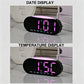 Digital alarm clock showing date and temperature on LED display
