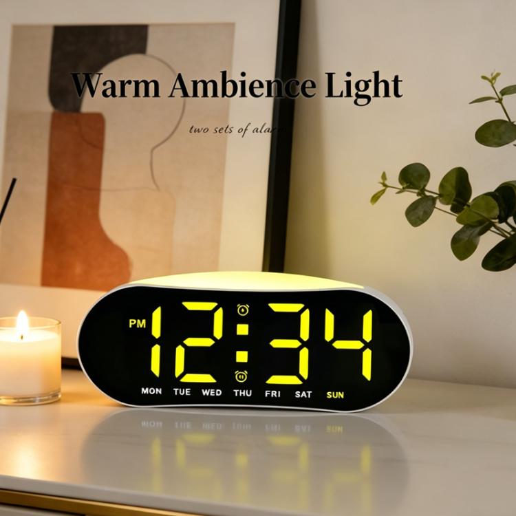 Digital alarm clock with yellow LED time display and black housing