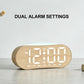 Digital alarm clock with white LED time display and wood-grain casing