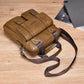 Tan/brown PU messenger bag with front zipper pocket and adjustable crossbody strap on wood