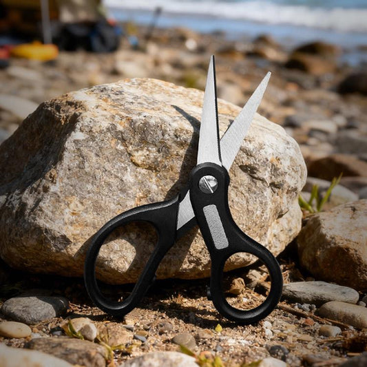 Black multifunctional fishing line cutter with two blades and oval finger grips