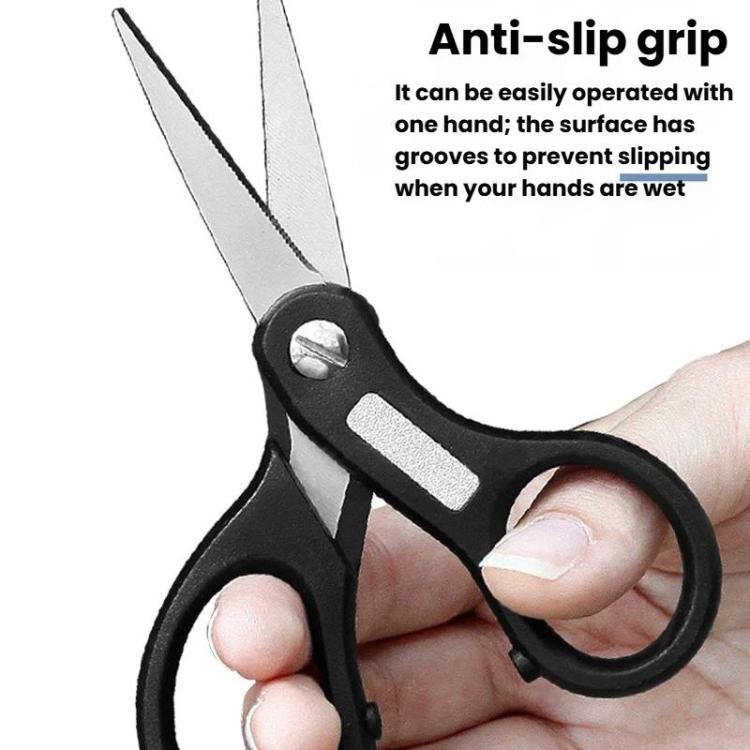 Black fishing line cutter with anti-slip grip held in a hand