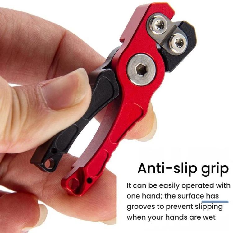 Mini fishing line cutter shears held in hand; red handle with black anti-slip grip