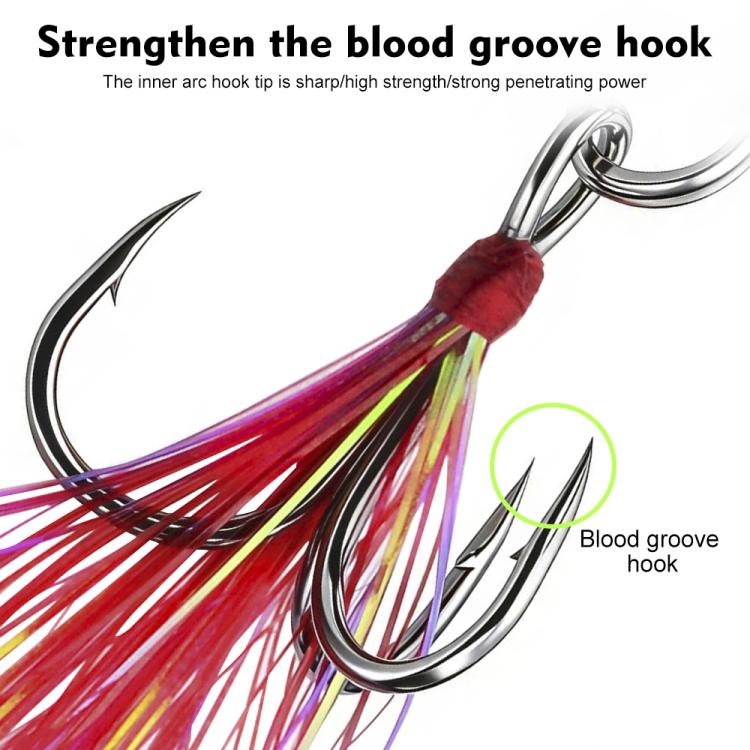 Close-up blood-groove treble hook with red and multicolor feather lure skirt