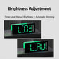 Black digital alarm clock display with bright green digits and brightness glow