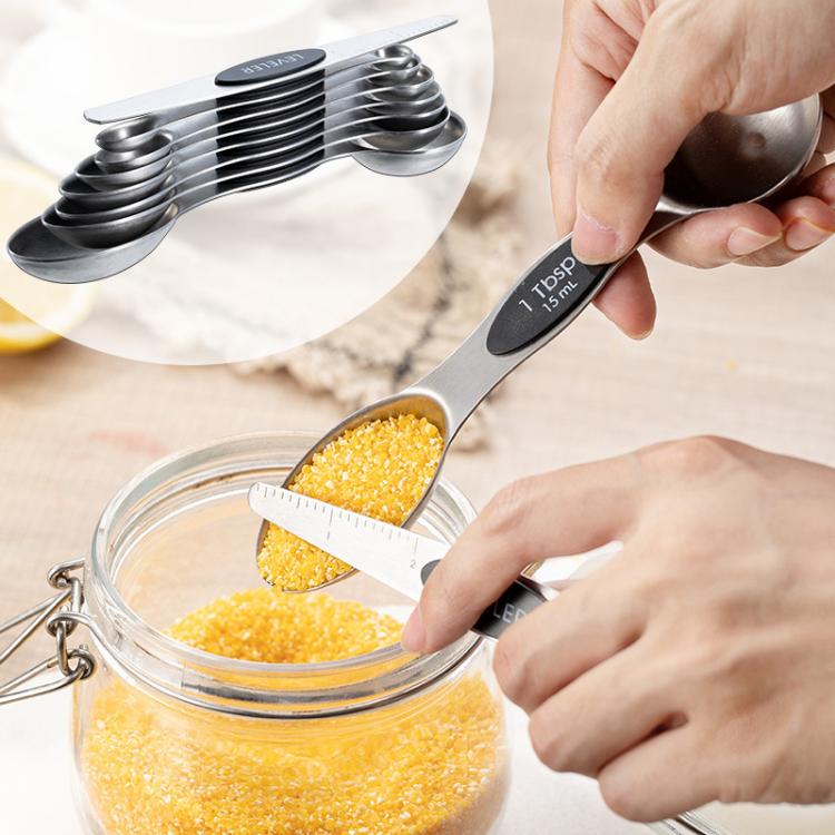 LsCook stainless steel double-ended measuring spoon with baking markings held for scooping