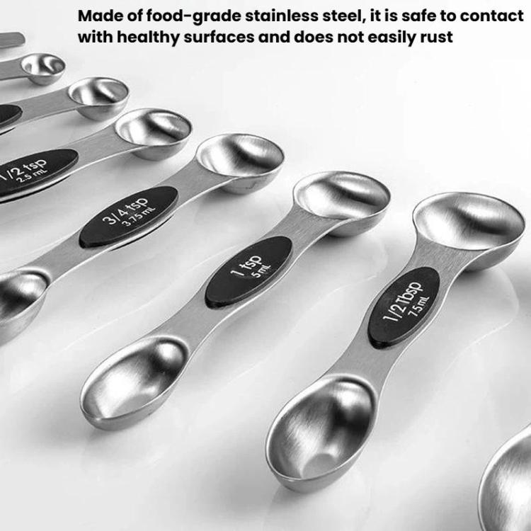 Stainless steel double-ended measuring spoons with black size markings, close-up