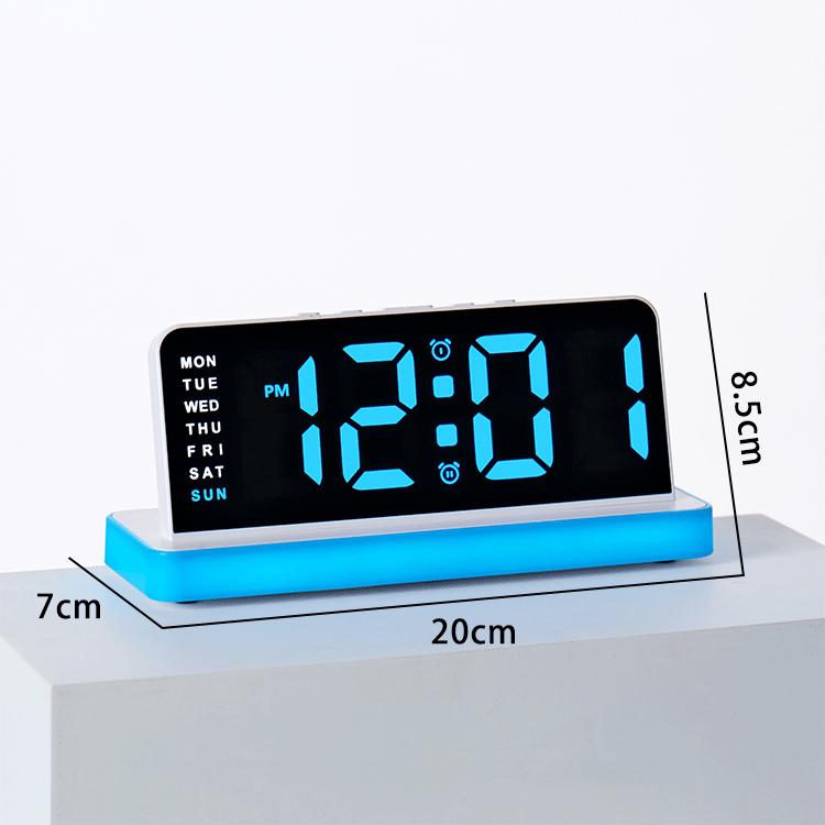 Desktop LED digital alarm clock with blue base, glowing time display and day abbreviations.