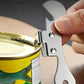 Compact stainless steel can opener blade gripping a can rim
