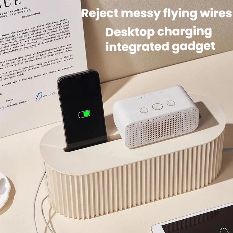 Desktop charging integrated gadget resting on cable management box, with ribbed sidewalls.