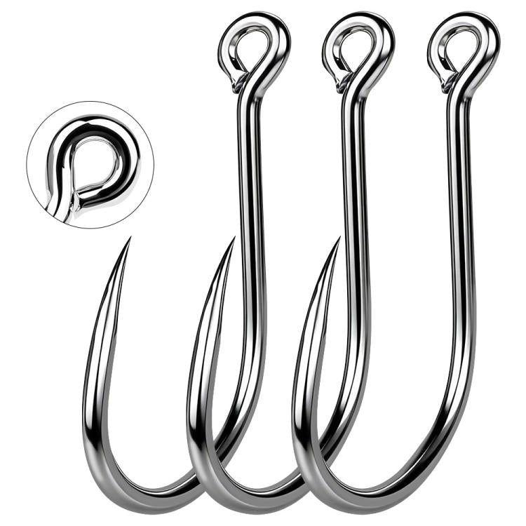 Close-up of three shiny silver fish hooks with ring eyes and curved barbed points