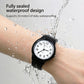 Black analog wristwatch on wrist with water splash, rubber strap and round white dial