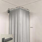 Grey shower curtain partition with corner ceiling rail and pleated curtain panels