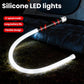 Flexible silicone LED light strip flashlight with bright white curved glow and red accents