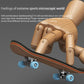 Wooden finger skateboard held by a hand figure, with blue wheels and black deck trim