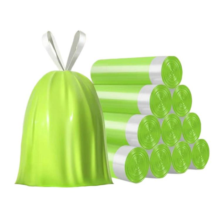 Green drawstring trash bag with matching rolls of green garbage bags