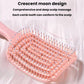 Pink crescent-shaped hair massage comb with tightly spaced flexible teeth