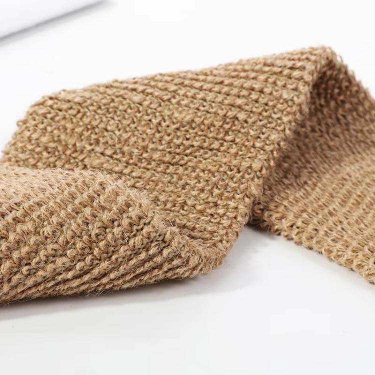 Close-up of textured jute brown scrubber surface with braided weave