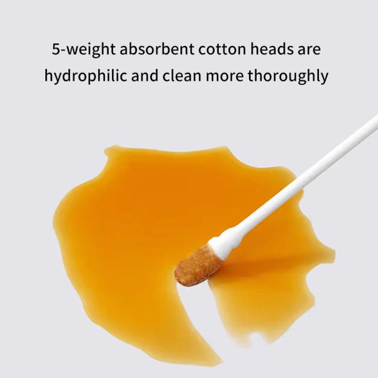 Cotton swab with absorbent tip applying orange liquid, white paper stick