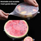 Clear silicone food storage lid with grip tabs, covering a sliced watermelon