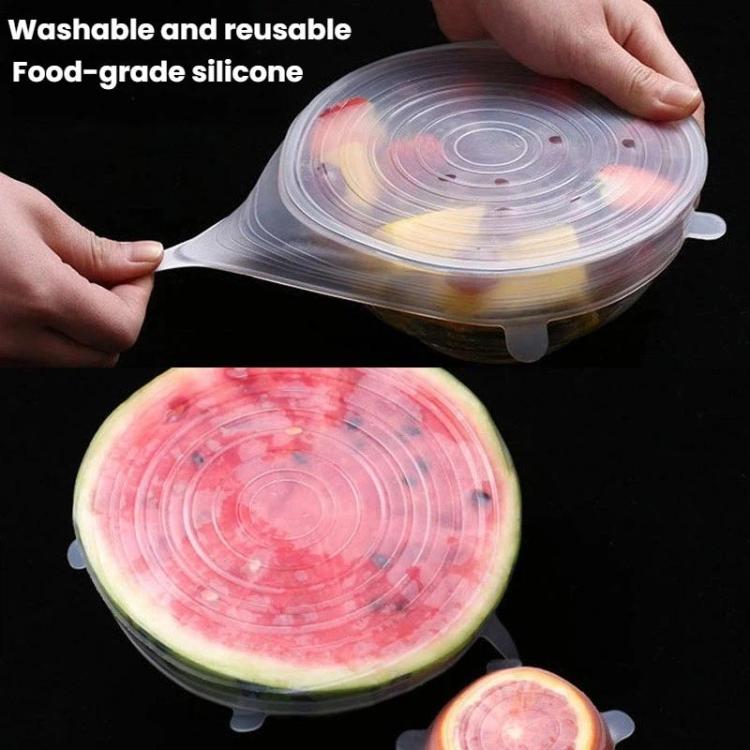 Clear silicone food storage lid with grip tabs, covering a sliced watermelon