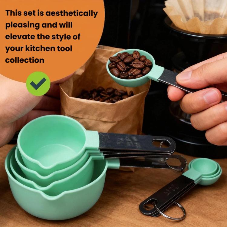 Mint green graduated measuring spoons with stainless steel clips, held in kitchen hands