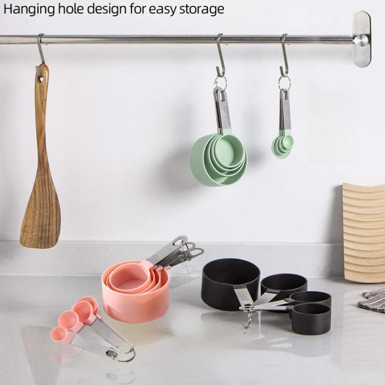 Hanging mint green silicone measuring spoons on a rail, stainless steel handles