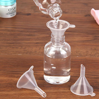 Clear plastic mini funnel with short spout and wide rim, for small bottles