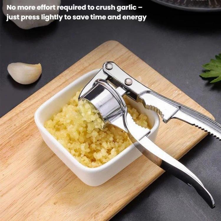 Garlic press squeezing tool dispensing minced garlic into a small white dish