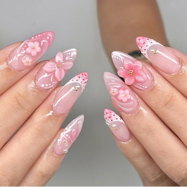 Pink and white glossy press-on nails with butterfly and 3D flower accents