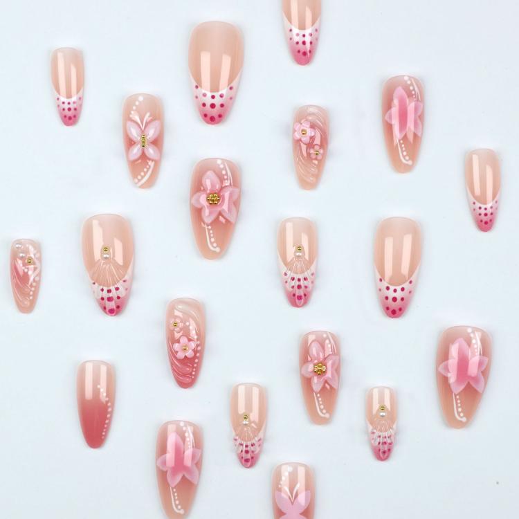 Pink press-on nail set with 3D flowers, bows, and French-tip style designs