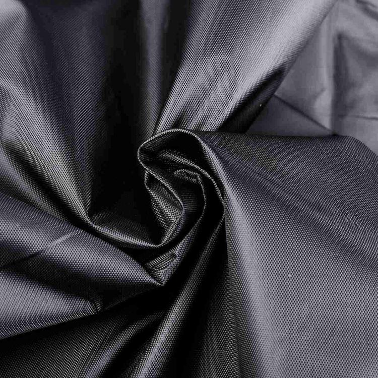 Black BBQ grill cover fabric close-up with smooth draped texture