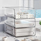 Clear acrylic desktop file rack with three open shelves and curved metal frame.