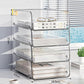 Clear acrylic desktop file rack with three open shelves and curved metal frame.