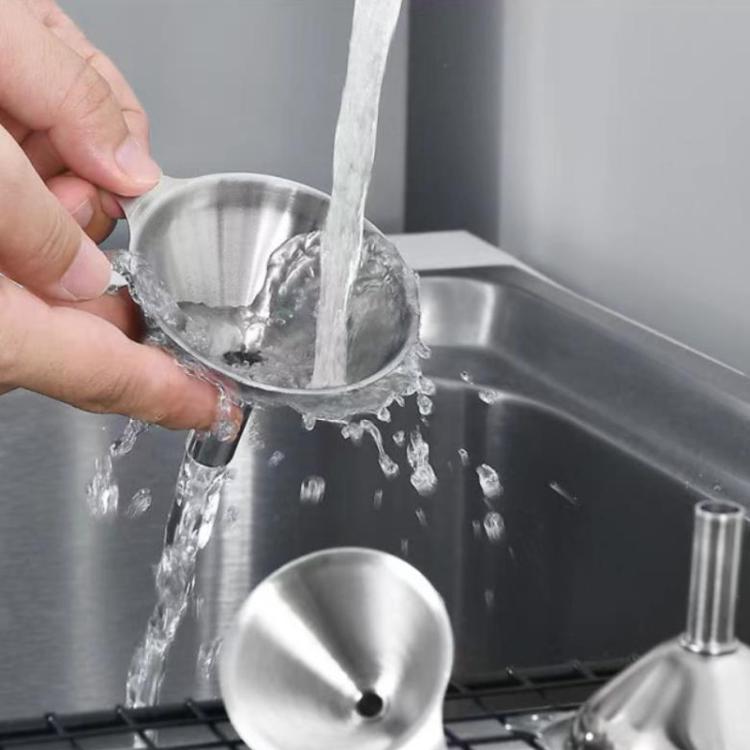 Stainless steel funnel dispenser pouring water into a sink basin