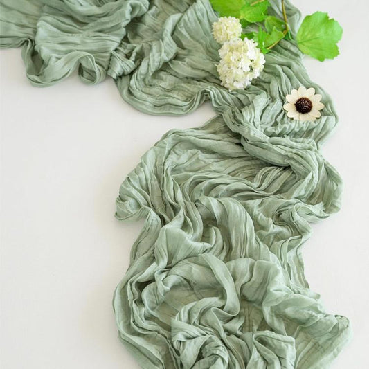 Sage green pleated gauze table runner with soft crinkle ruffle texture