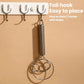 Stainless steel double-coil whisk hanging on wall hooks by the handle