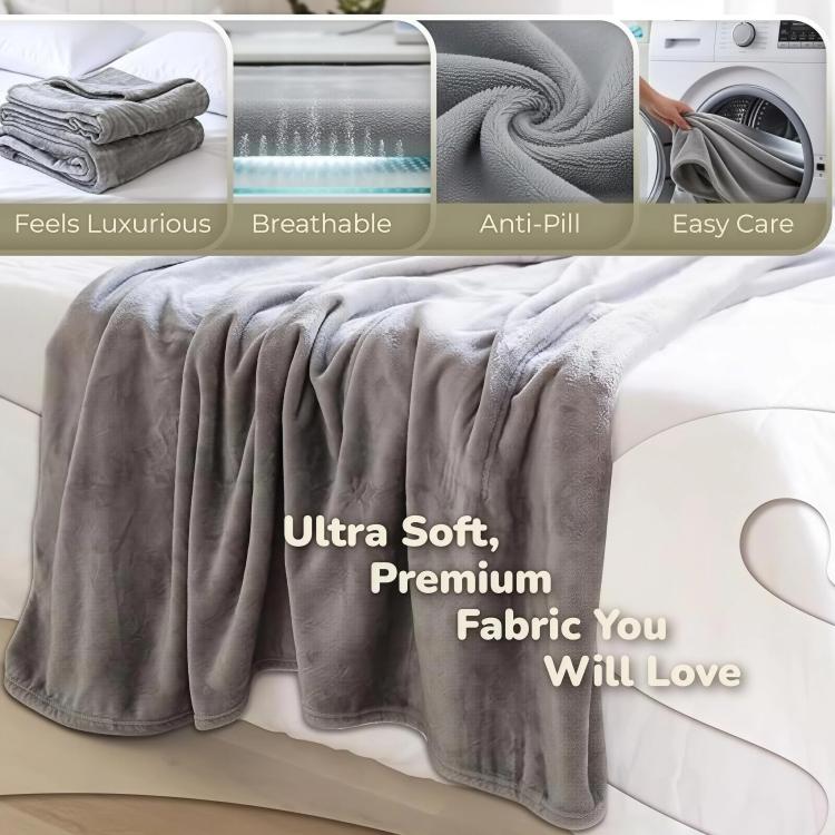 Gray plush throw blanket with sleeve design, folded on a sofa