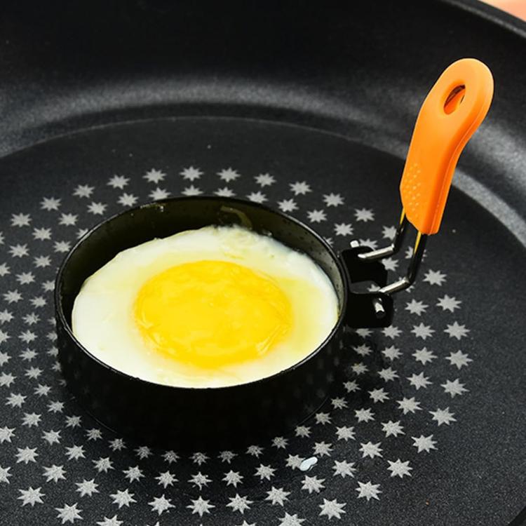 Round black non-stick egg pan with orange silicone handle and circular rim