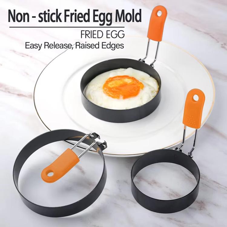 Set of round non-stick egg molds with orange silicone handles and raised rim