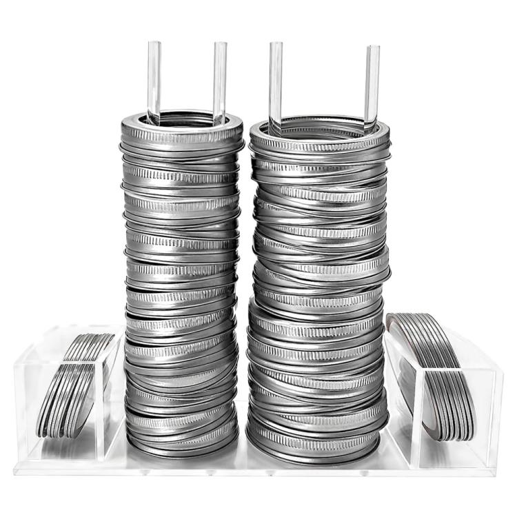 Clear acrylic mason jar lid organizer holding tall stacks of silver lid rings and lids