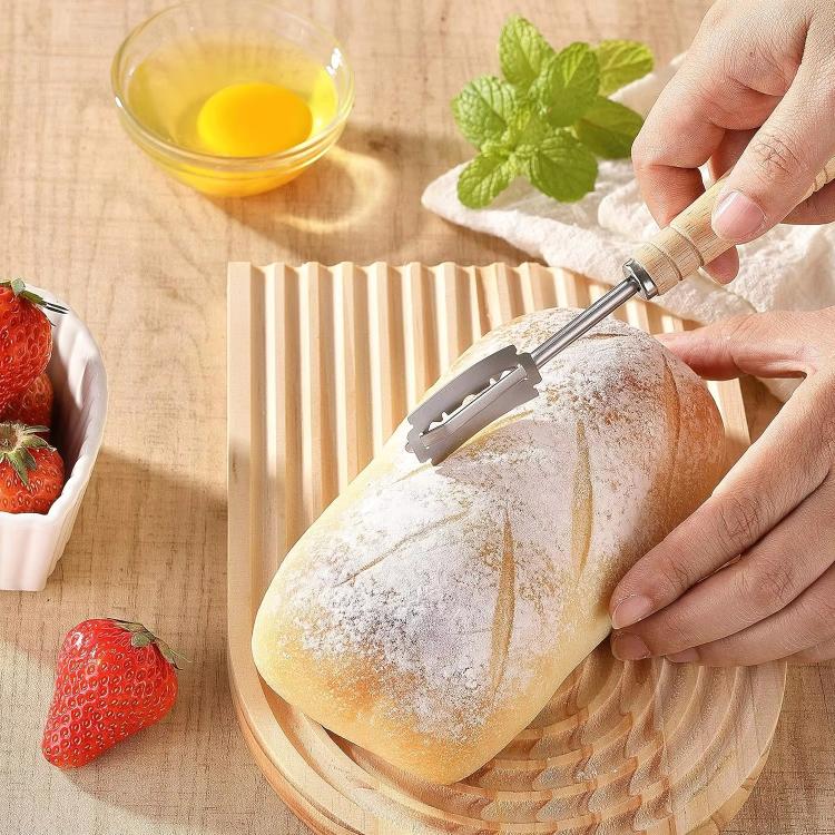 Bread trimming knife slicing a loaf with stainless steel blade and wooden handle