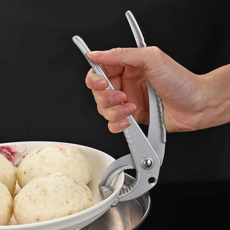 Aluminum heat-resistant serving tray lifter tong held by hand over pot