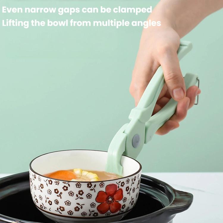 Bowl tong clamp gripping a patterned bowl to lift contents securely
