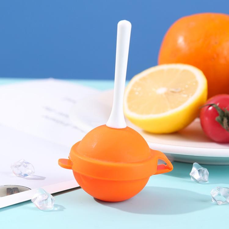 Lollipop-shaped ice pop mold with orange round silicone shell and white stick